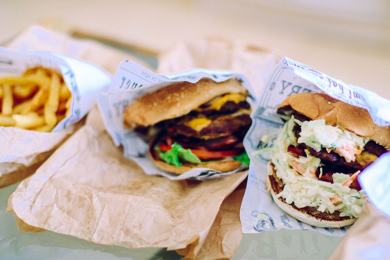 Mouth-watering cheeseburger with fresh lettuce, tomato, and fries, perfect for lunch or dinner.